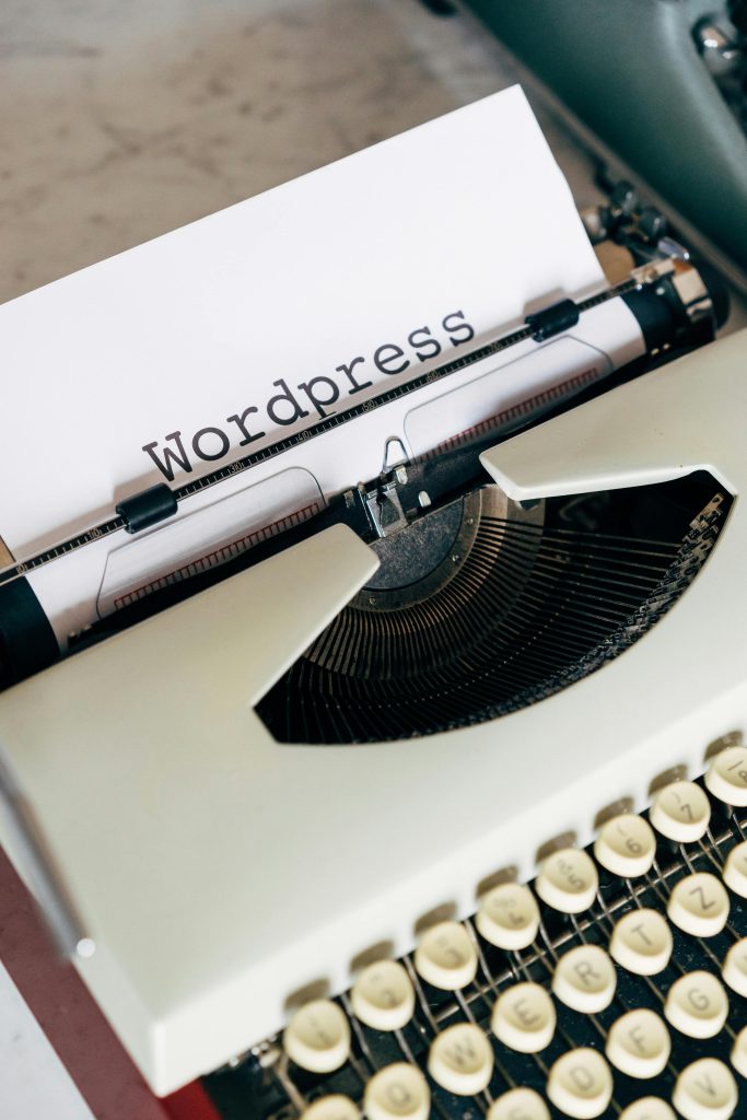 Close-up of a vintage typewriter with 'Wordpress' typed on paper, conveying a classic theme.